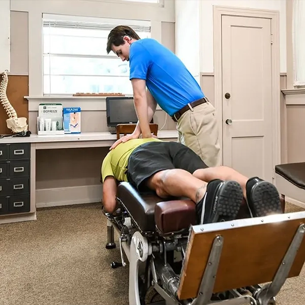 Chiropractor Tyler W. Wright Adjusting A Patient